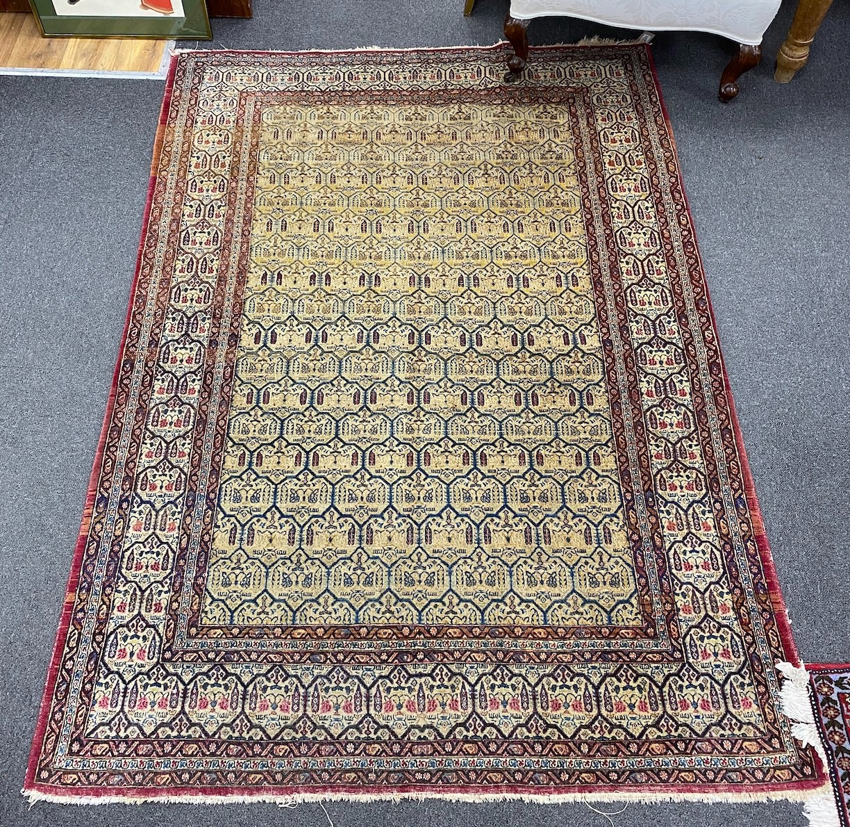 An antique North West Persian faded peach ground rug, 200 x 148cm